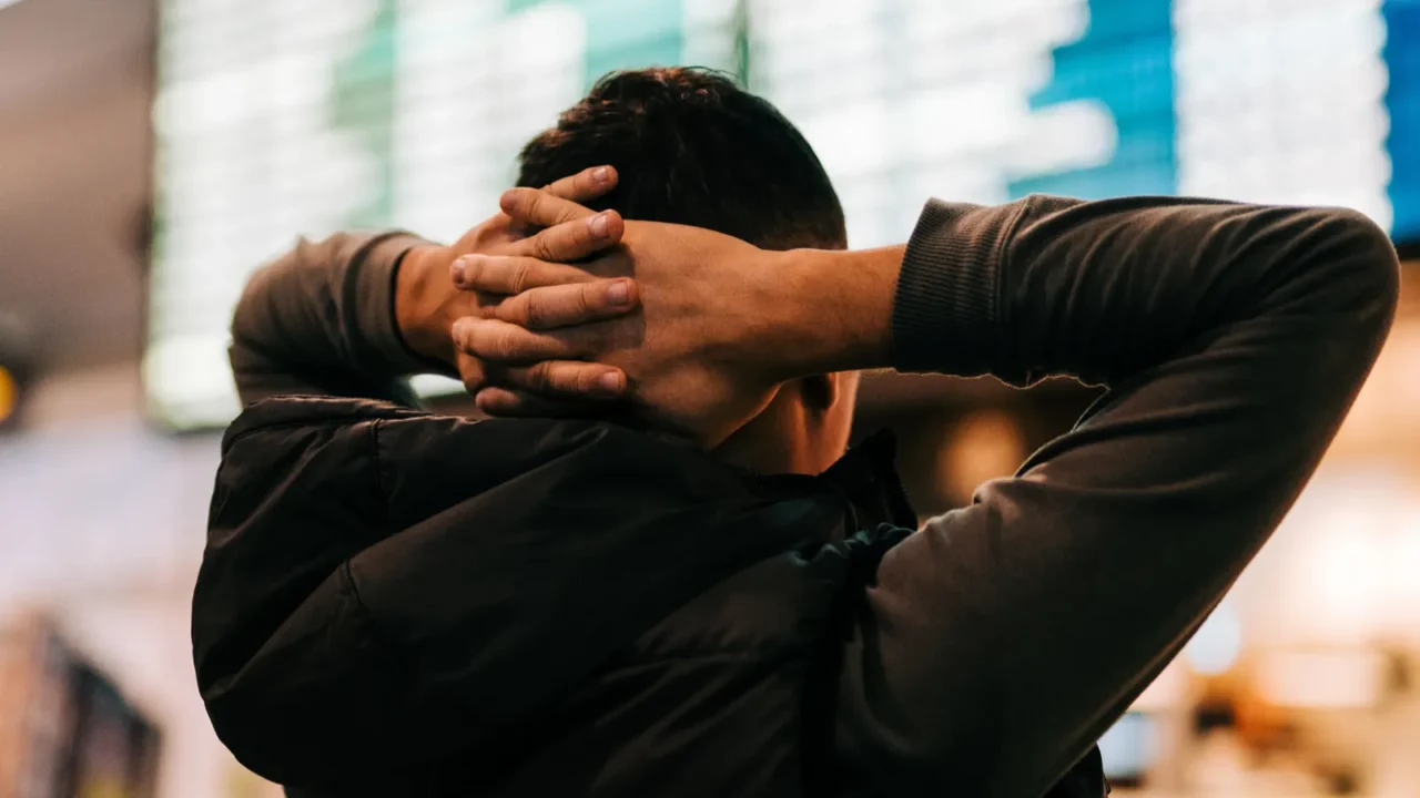 businessman on a background of departure board at airport