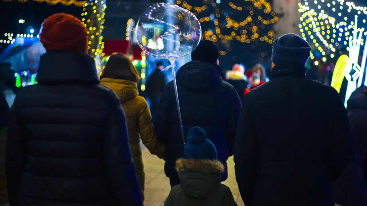 christmas market at city square in night unknown people walk