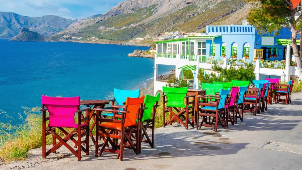 colorful wooden tables and chairs on greek island
