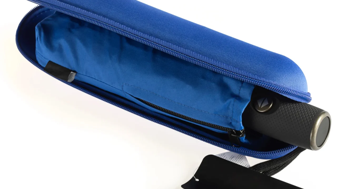 compact waterproof umbrella with sleeve in hard case isolated on