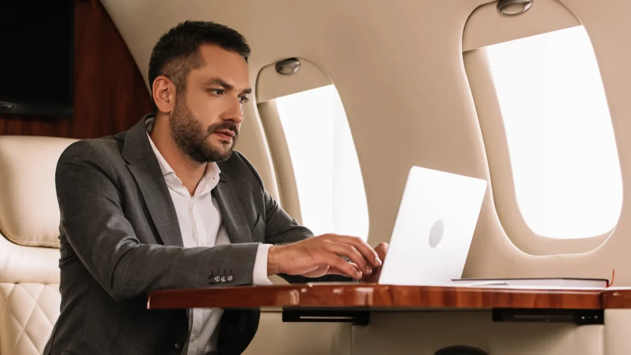 cropped view of woman sitting near handsome businessman using laptop