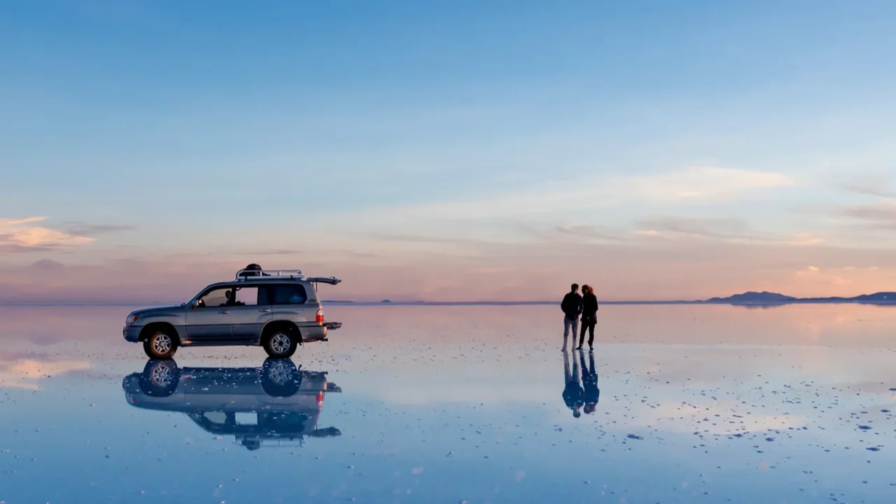 exciting scenery of spacious salar de uyuni with couple and