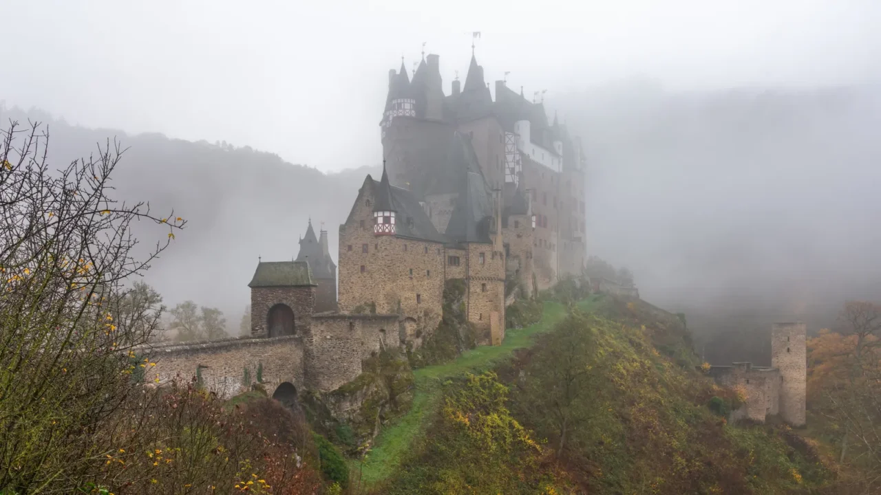 experience the enchanting view of eltz castle shrouded in autumn