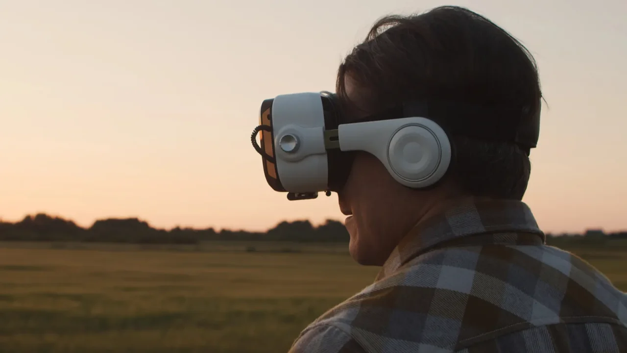 farmer in virtual reality helmet in front of a sunset