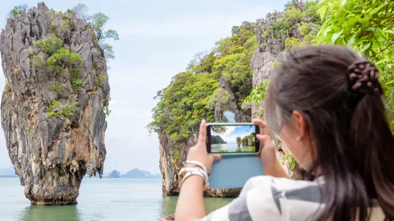 female traveler shooting natural view by mobile phone
