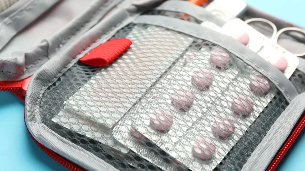 first aid kit on light blue background closeup