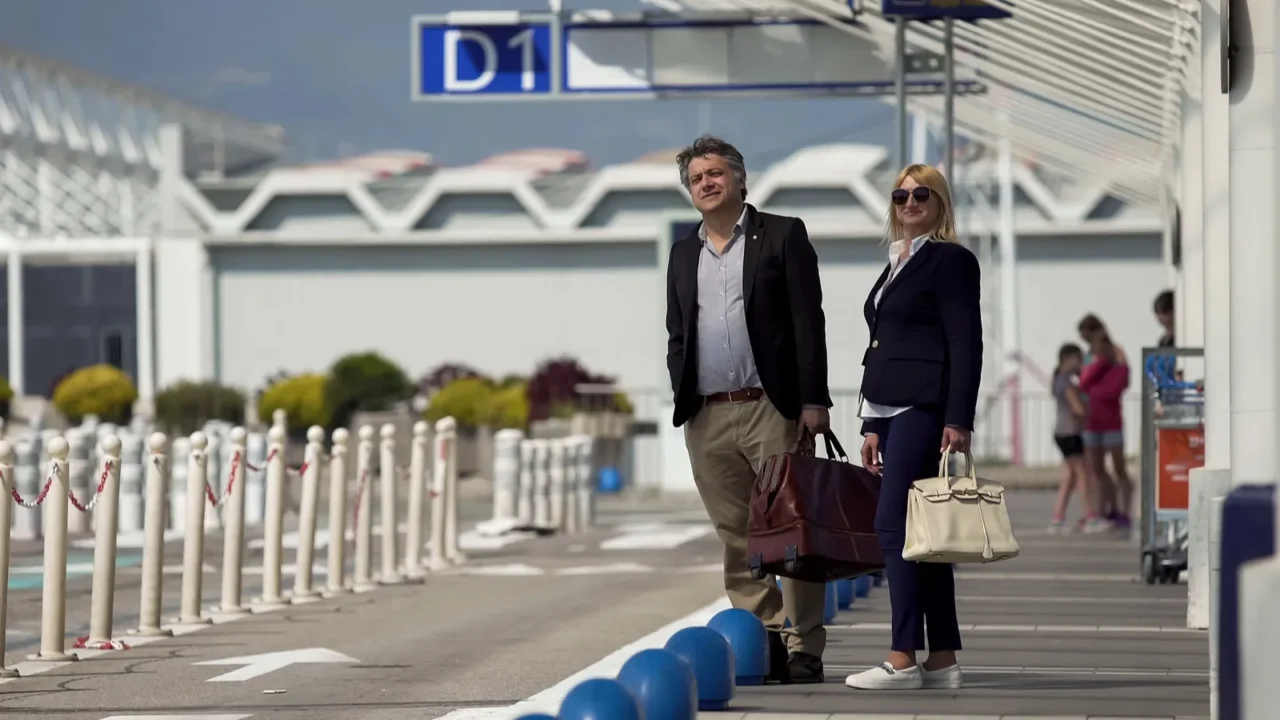 foreign tourists with bags waiting for shuttle bus near airport