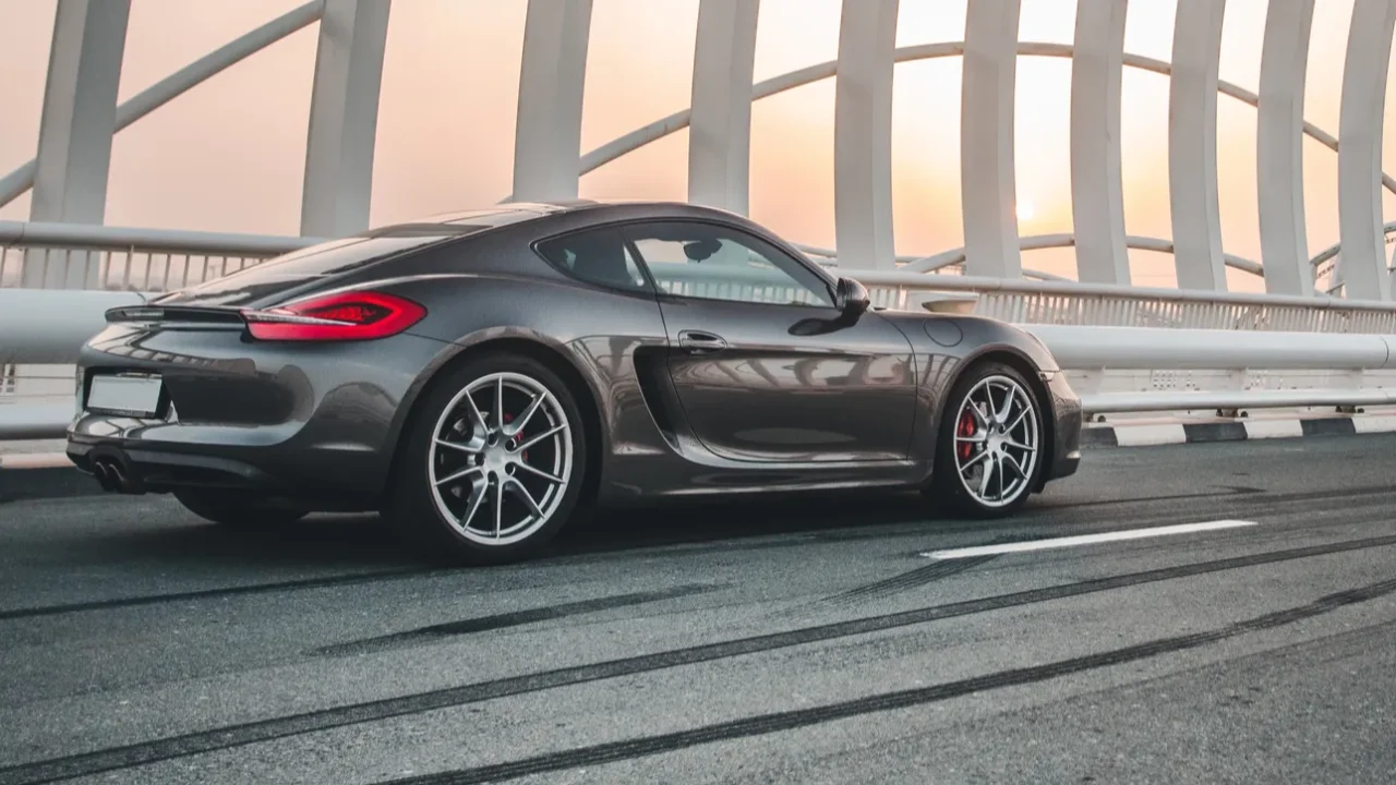 grey color sport car parking over a design bridge