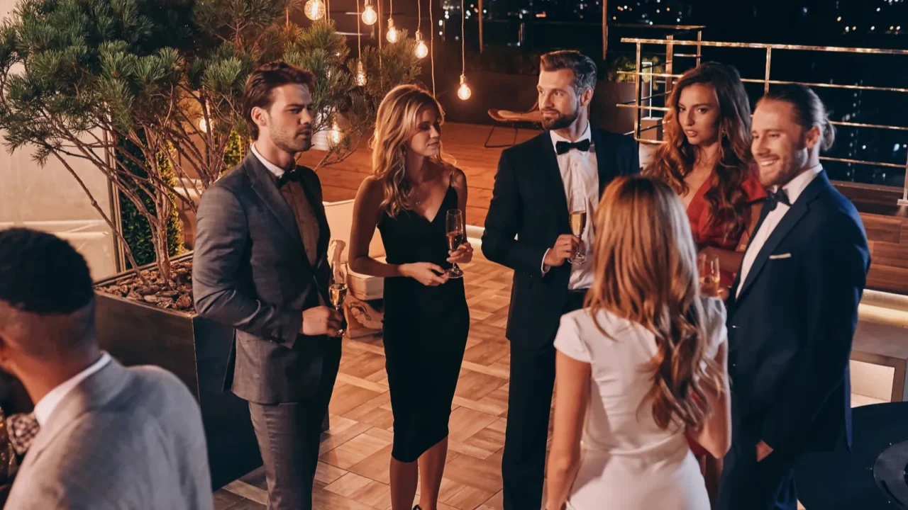 group of people in formalwear communicating and smiling while spending