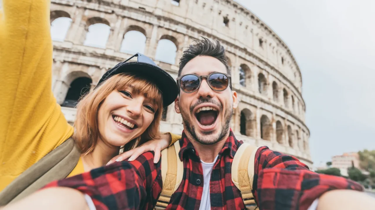 happy couple visiting colosseum in rome italy young friends takes