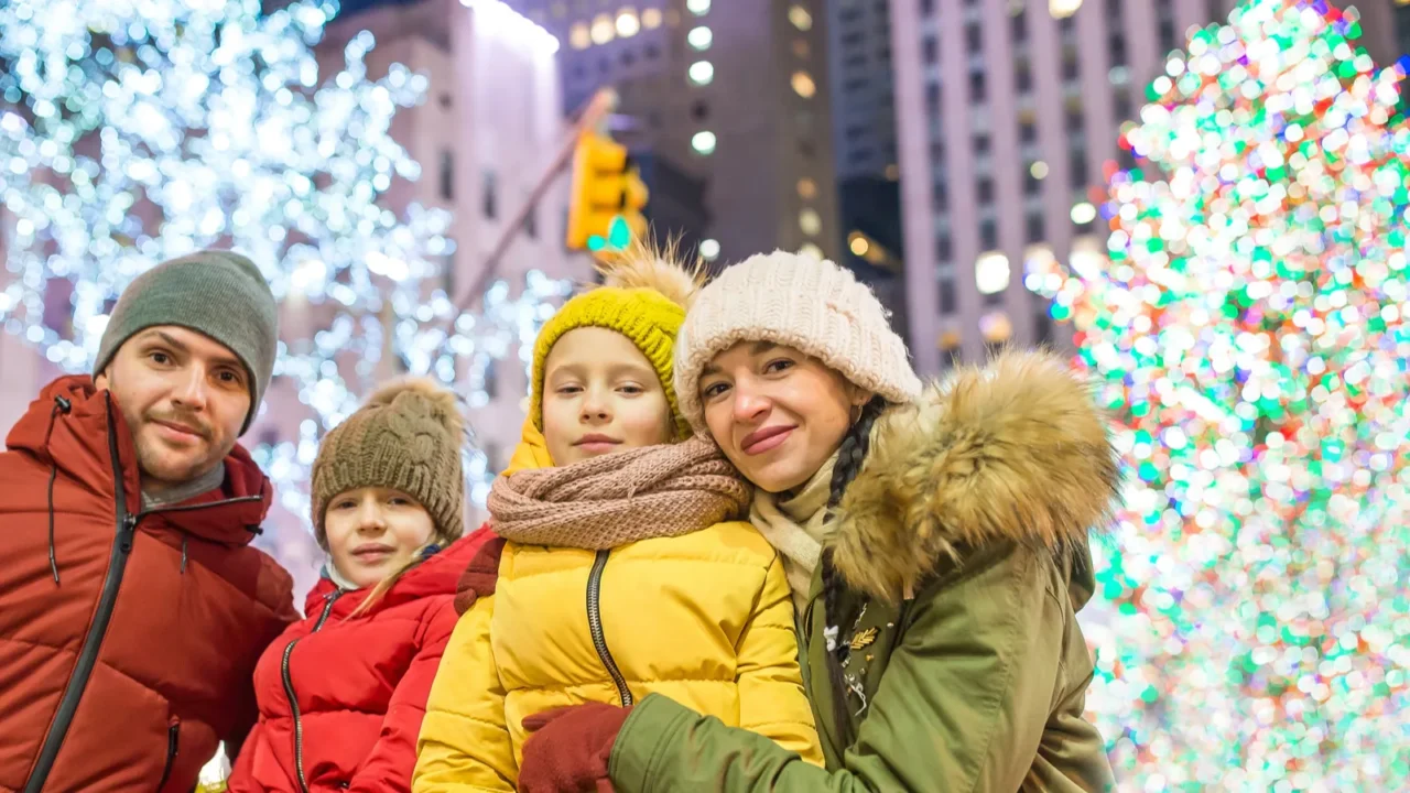 happy family on the background of the rockefeller christmas tree