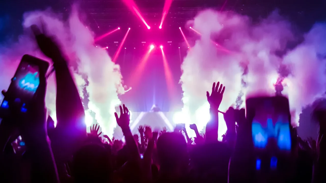 happy people dance in nightclub party concert