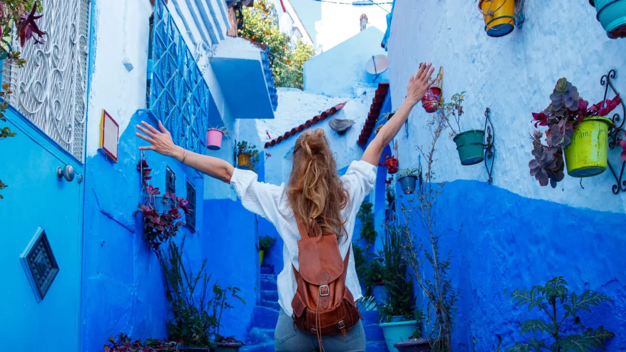 happy woman tourist in chefchaouen blue street travel in morocco