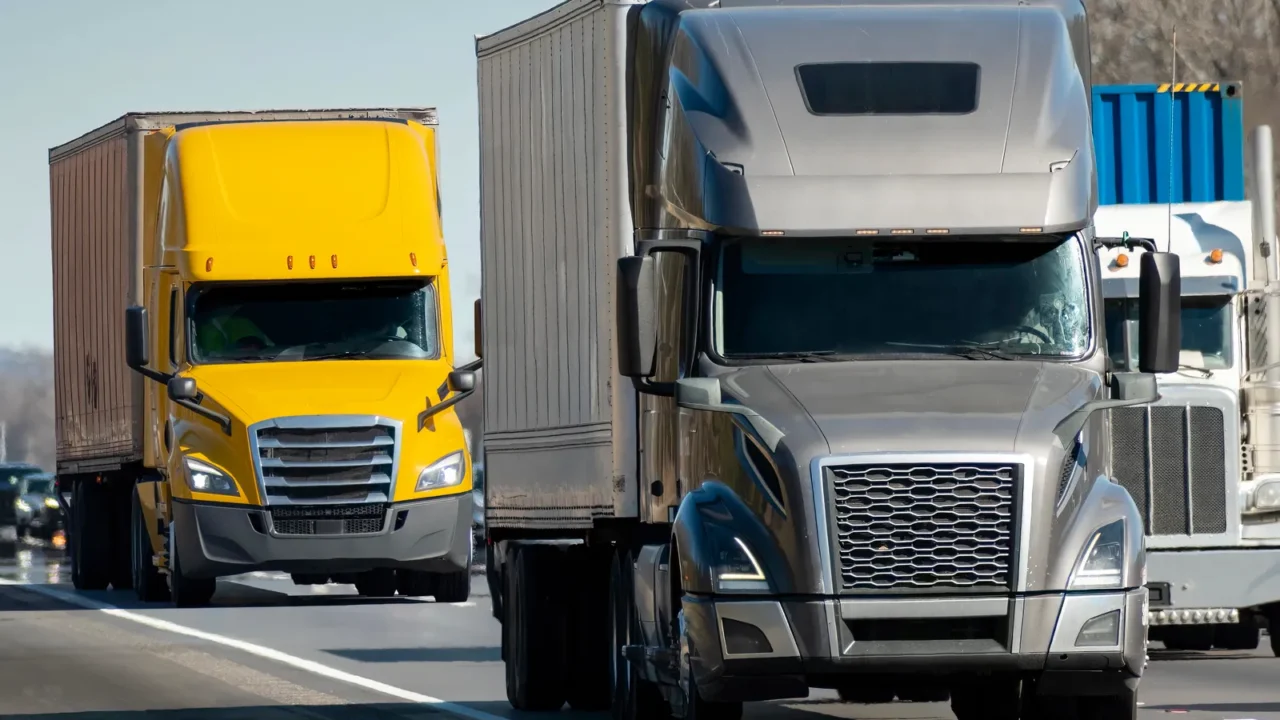 horizontal shot of a heavy semi trucks convoy on the