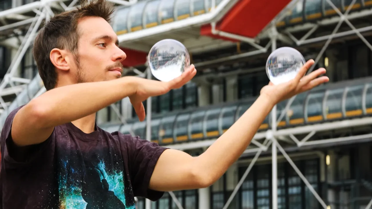 juggler with crystal balls shows his art to the public