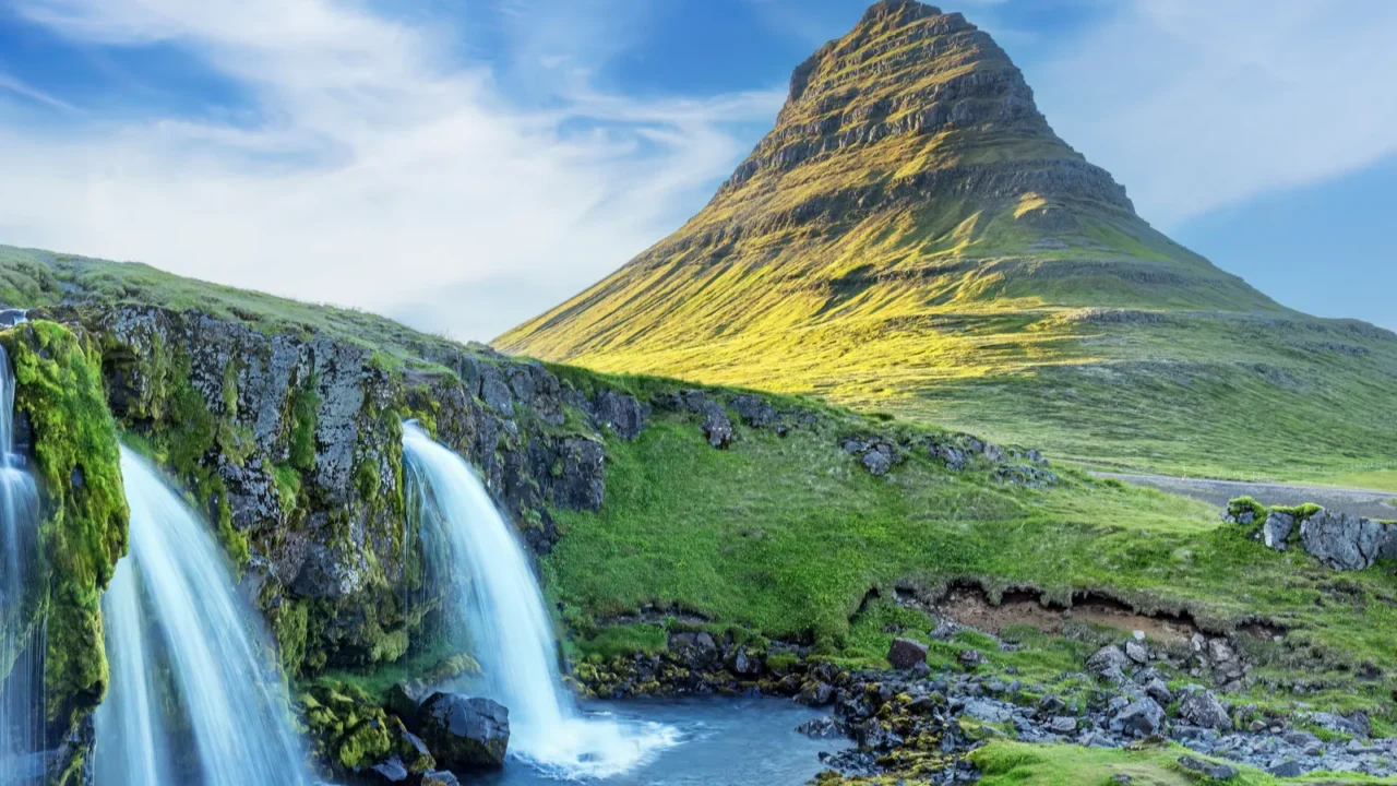 kirkjufellsfoss waterfall and kirkjufell volcano in summer iceland europe