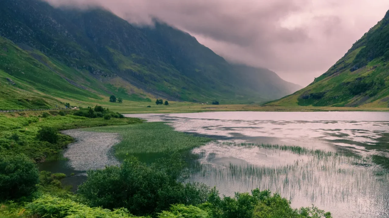 lake and mountains with dramatic clouds scotland