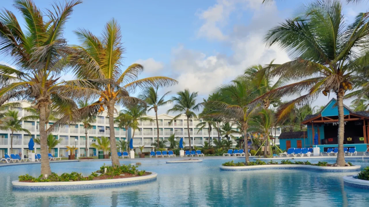 large caribbean swimmming pool with hotel in background