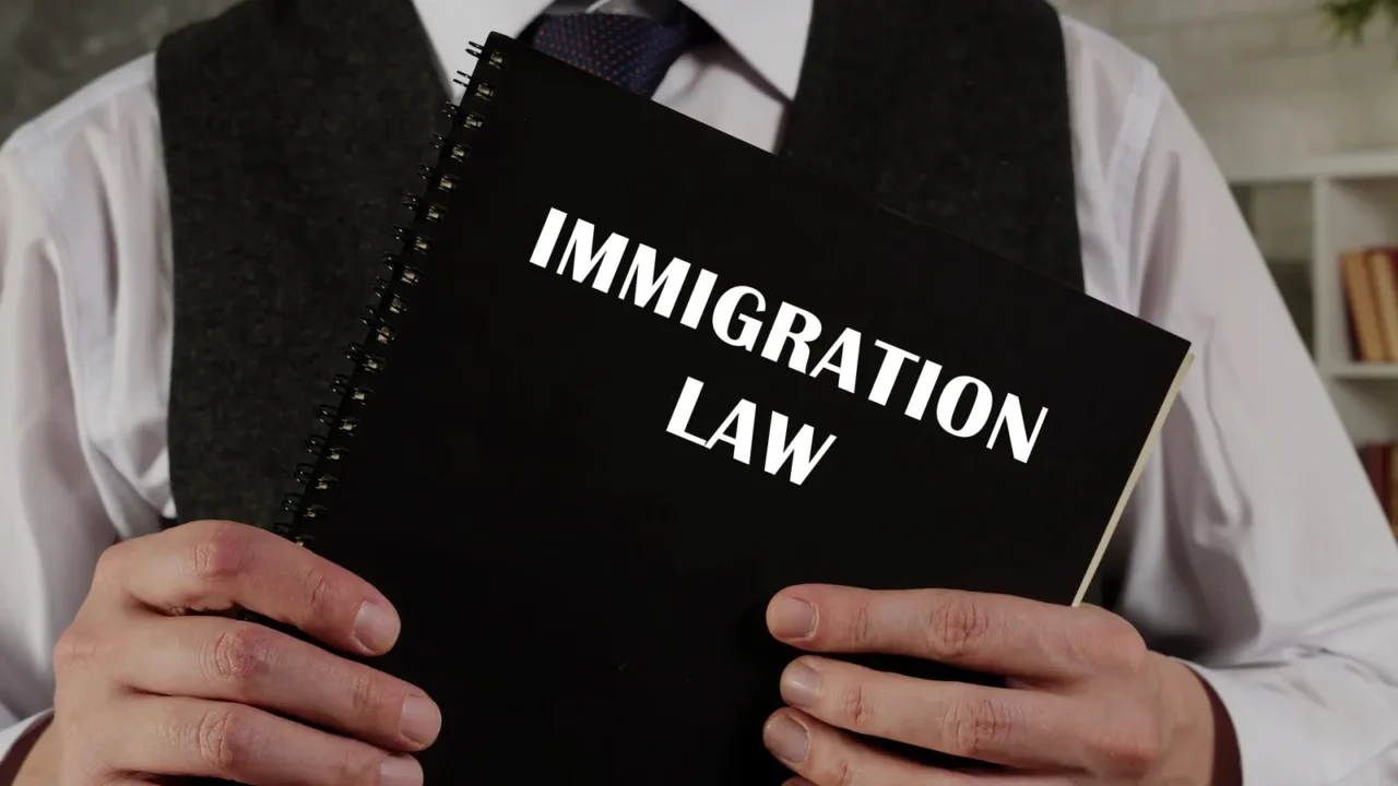 lawyer holds immigration law book immigration lawrefers to the national