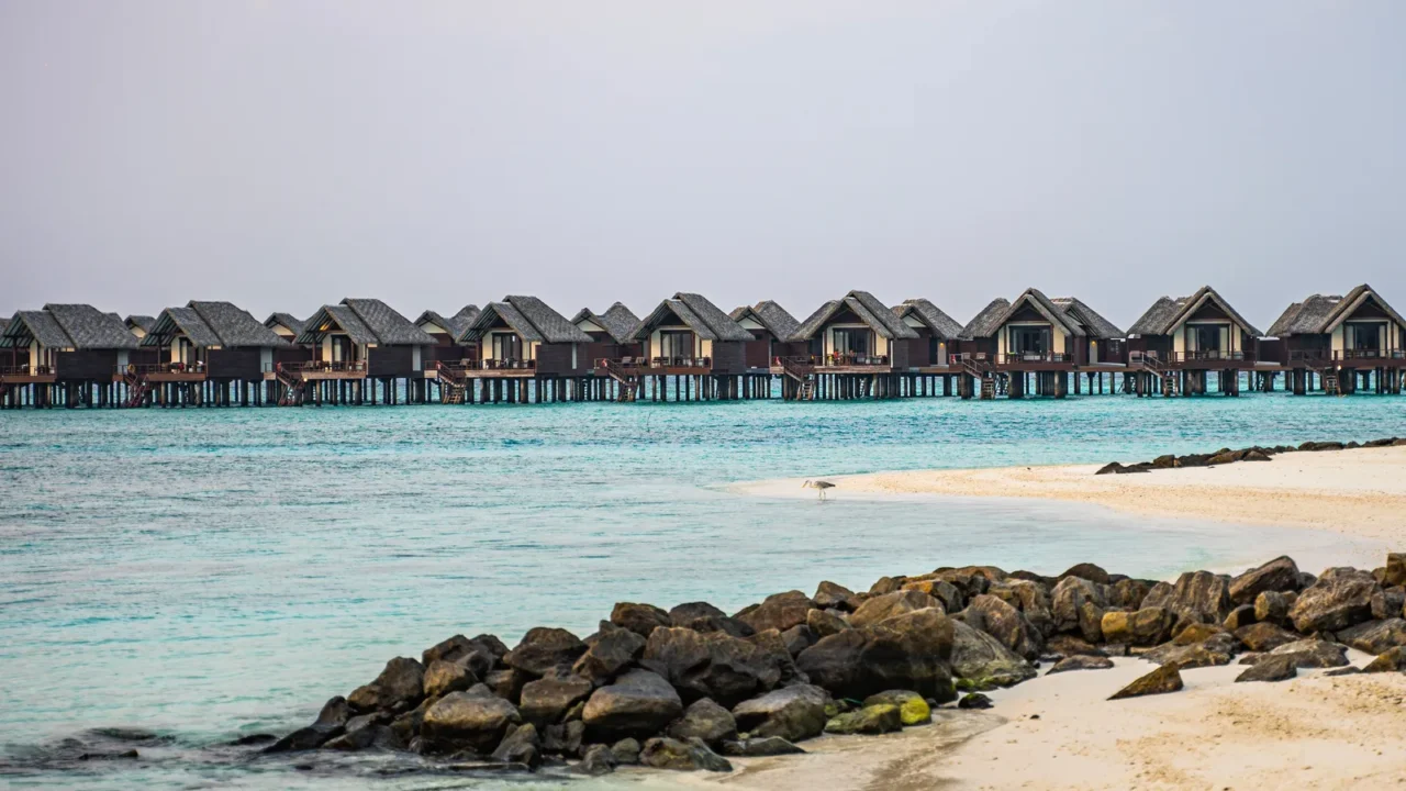 luxury over water villas on stilts stretch across turquoise waters