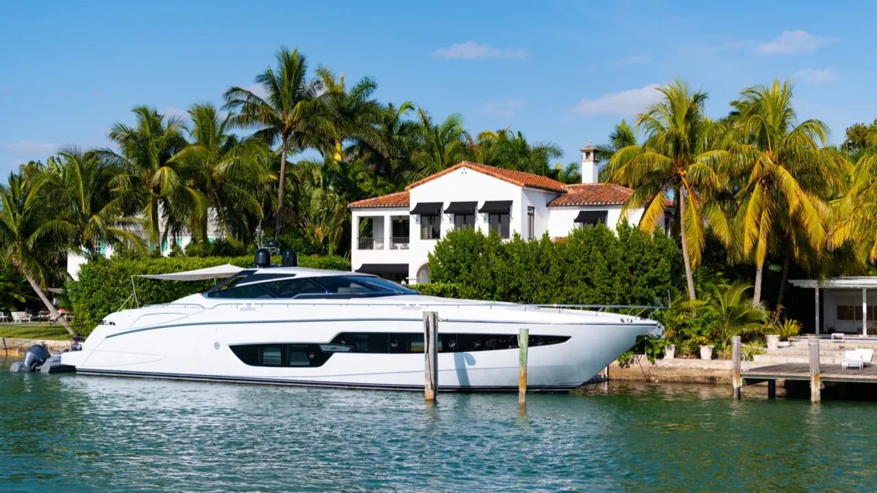 luxury private yacht in miami bay with palm trees