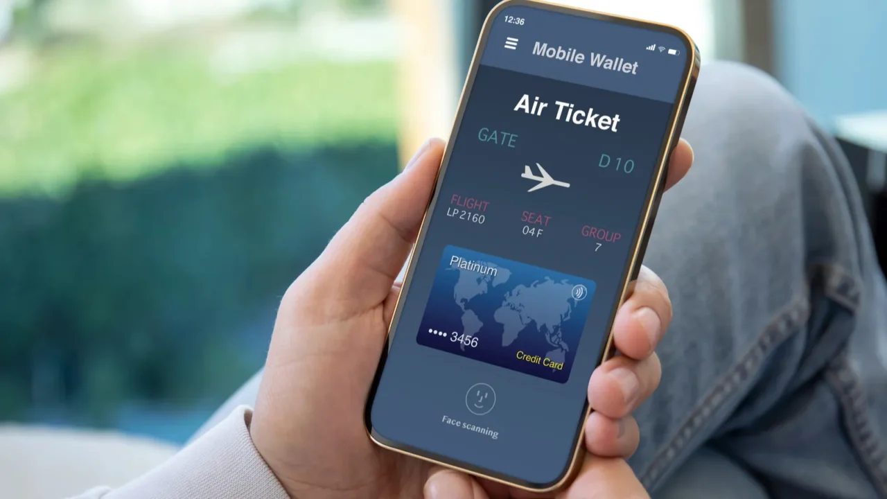 male hands holding phone with airplane ticket application airlines on