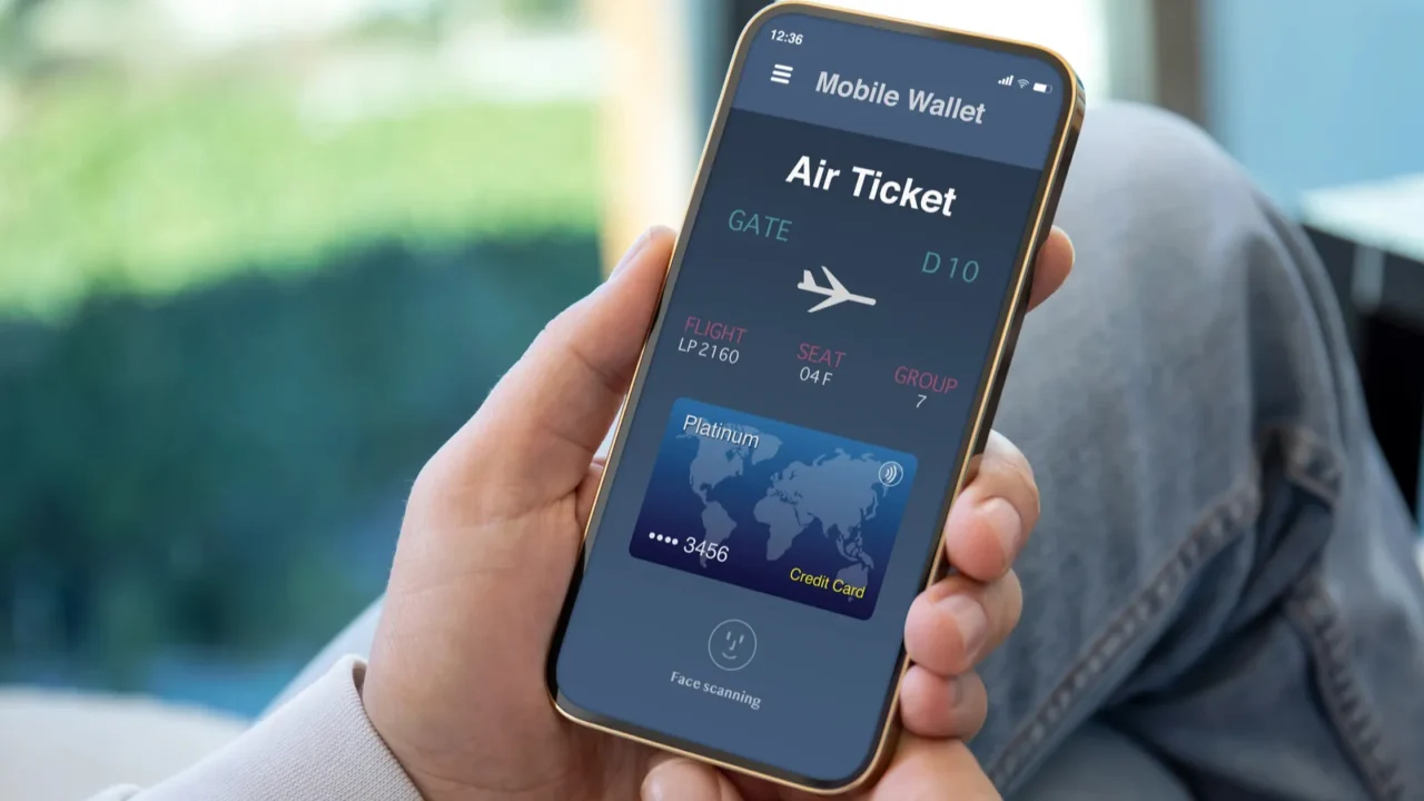 male hands holding phone with airplane ticket application airlines on