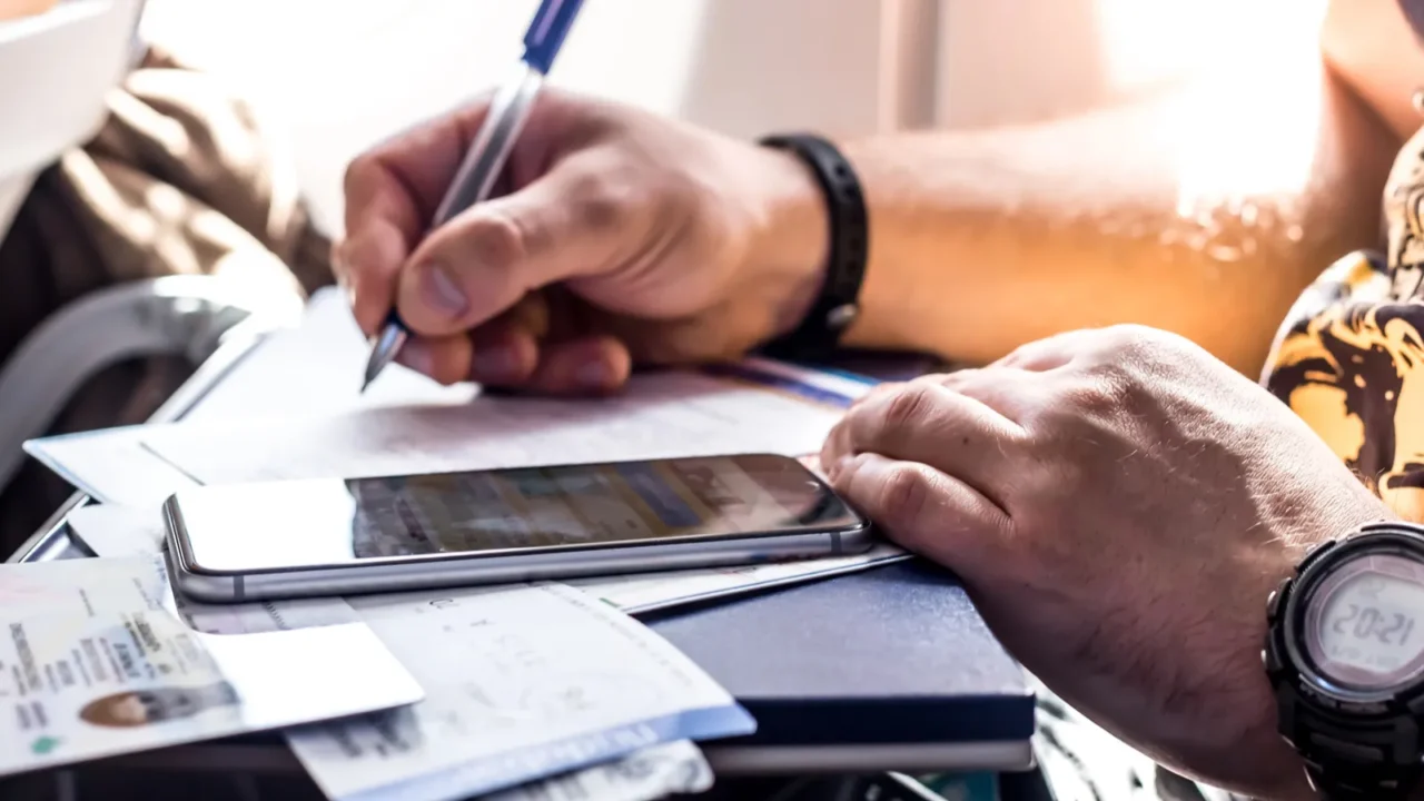 man filling immigration form
