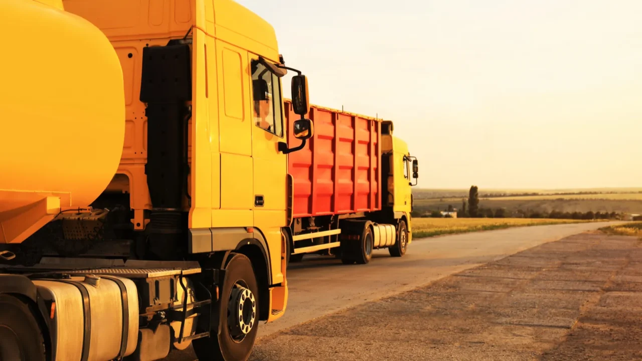 modern bright trucks on country road space for text