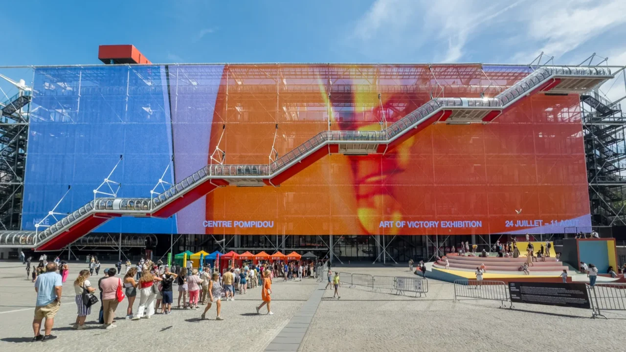 modern facade with screen at centre pompidou with long queue