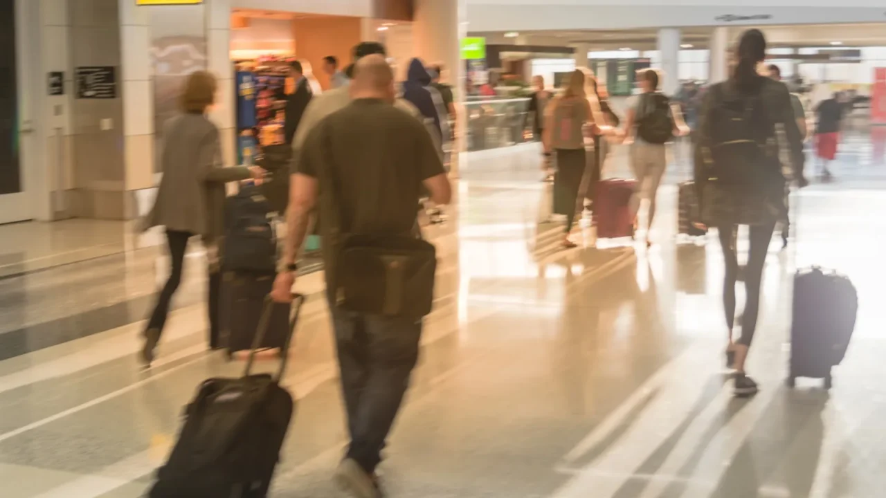 motion blurred motion people walking with luggage at american airport