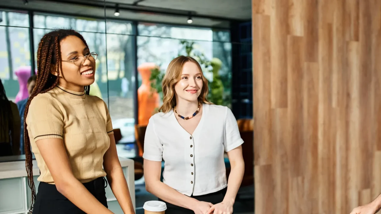 multicultural colleagues in casual attire standing around with luggage in