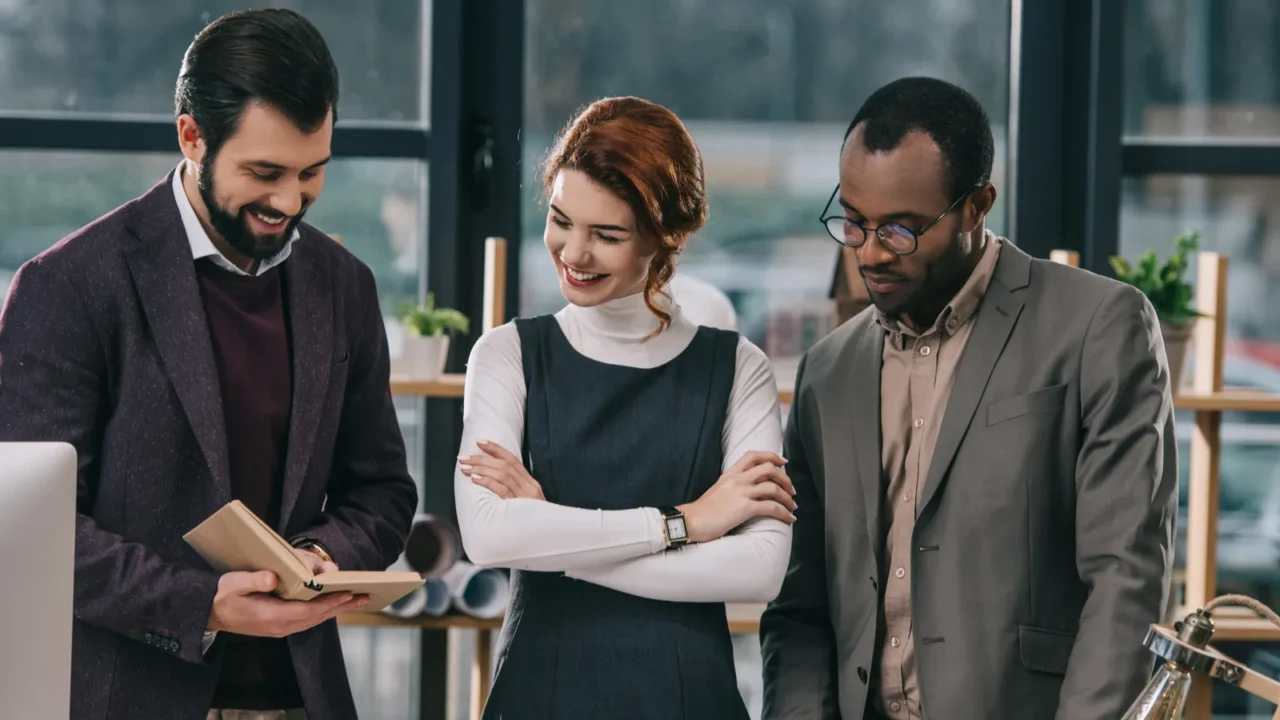 multiethnic architects discussing work in modern office