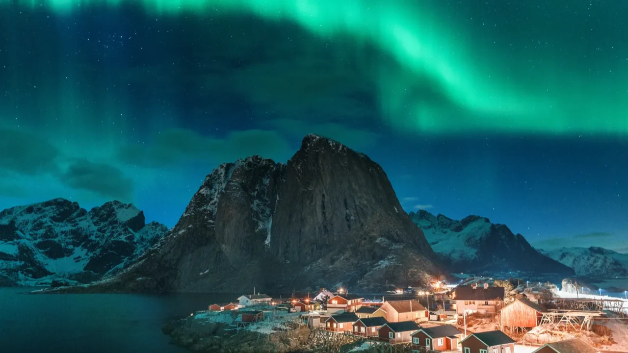 northern lights over hamnoy in lofoten island with mountains and