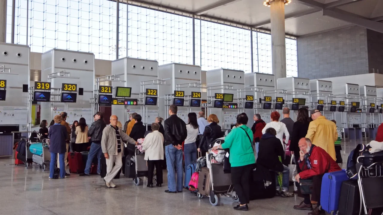 passengers waiting to check in for flights in terminal three