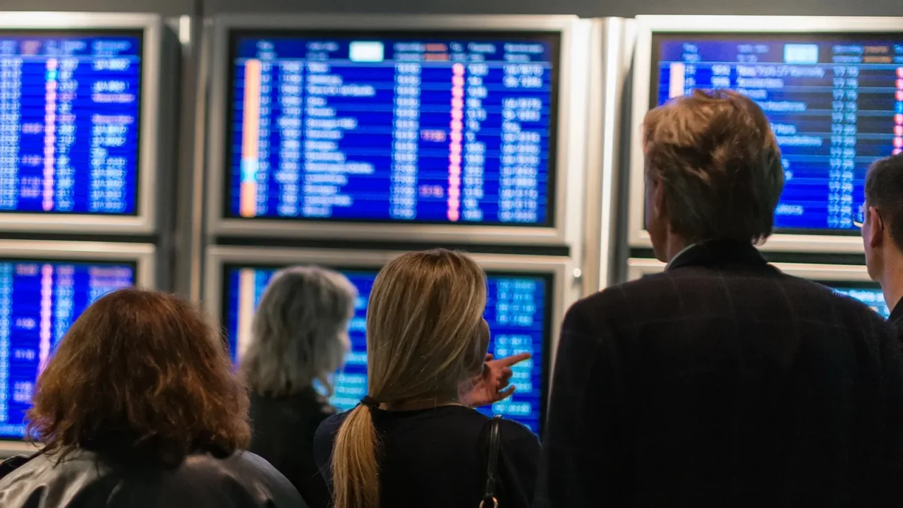 people waiting for flight at the airport back view