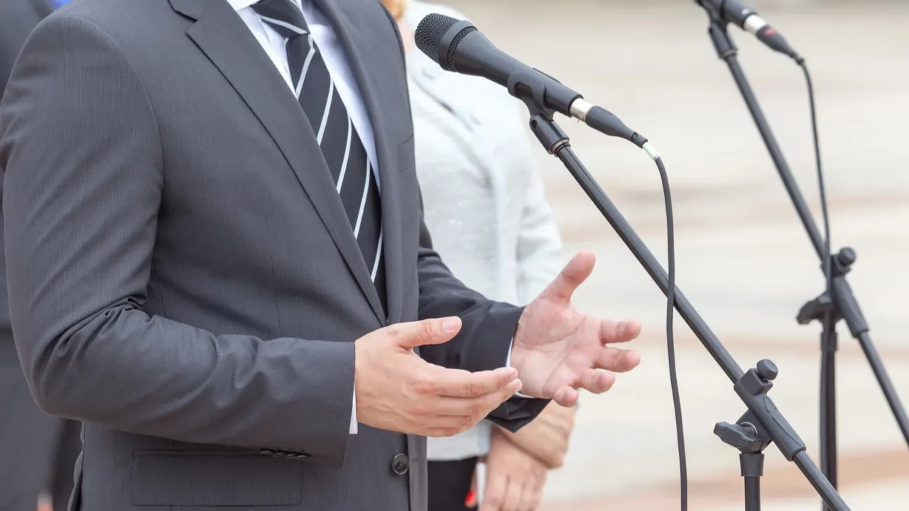 politician is giving a speech political rally