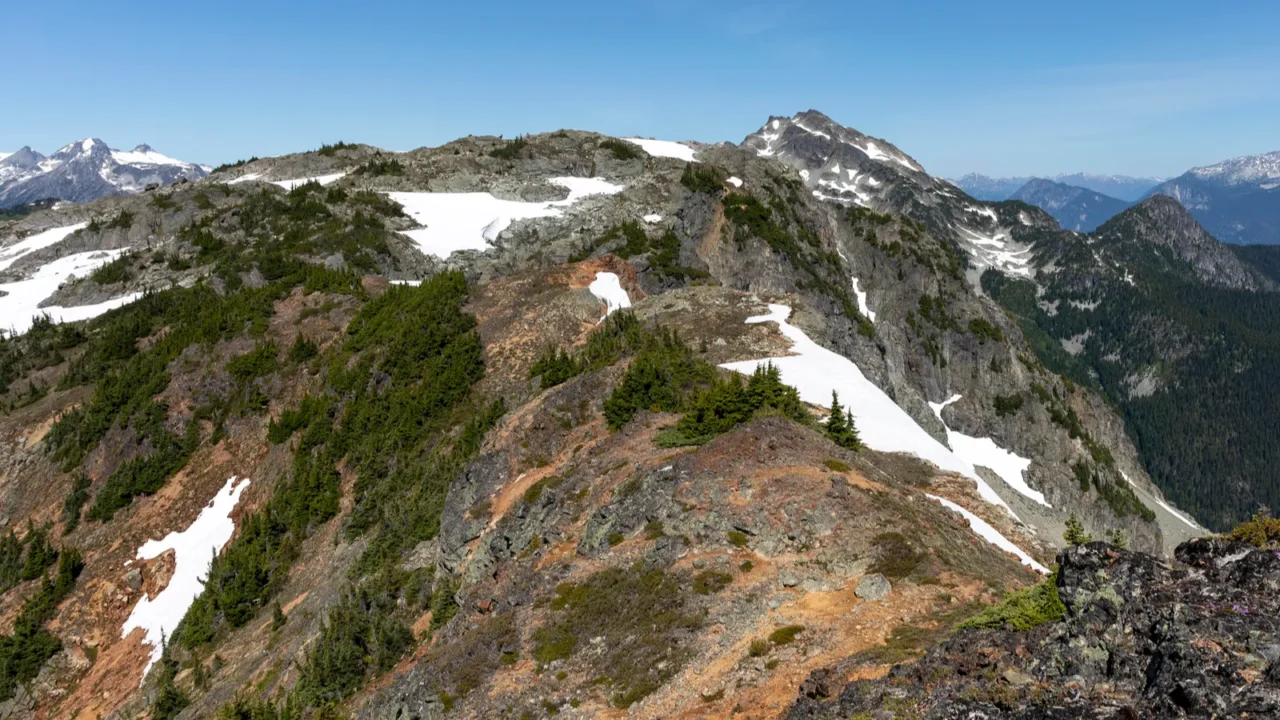scenic landscape of rocky mountain ridge top and snow capped