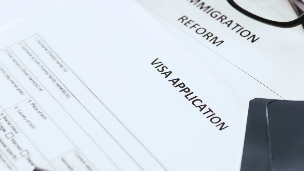 selective focus documents with lettering near glasses and passports