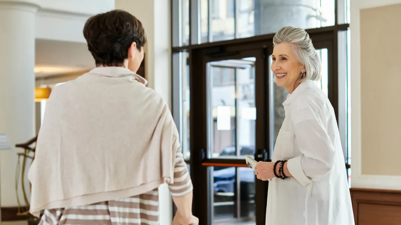 senior lesbian couple walk hand in hand through a bustling