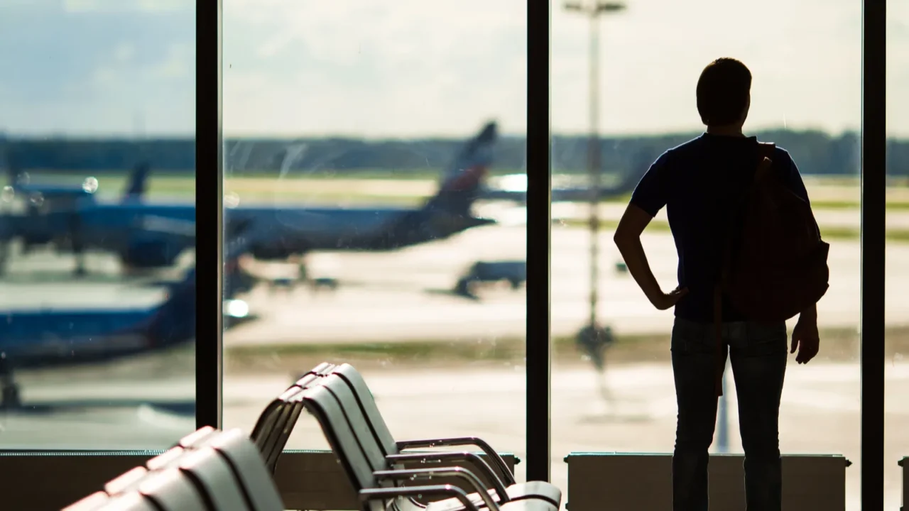 silhouette of a man waiting to board a flight in
