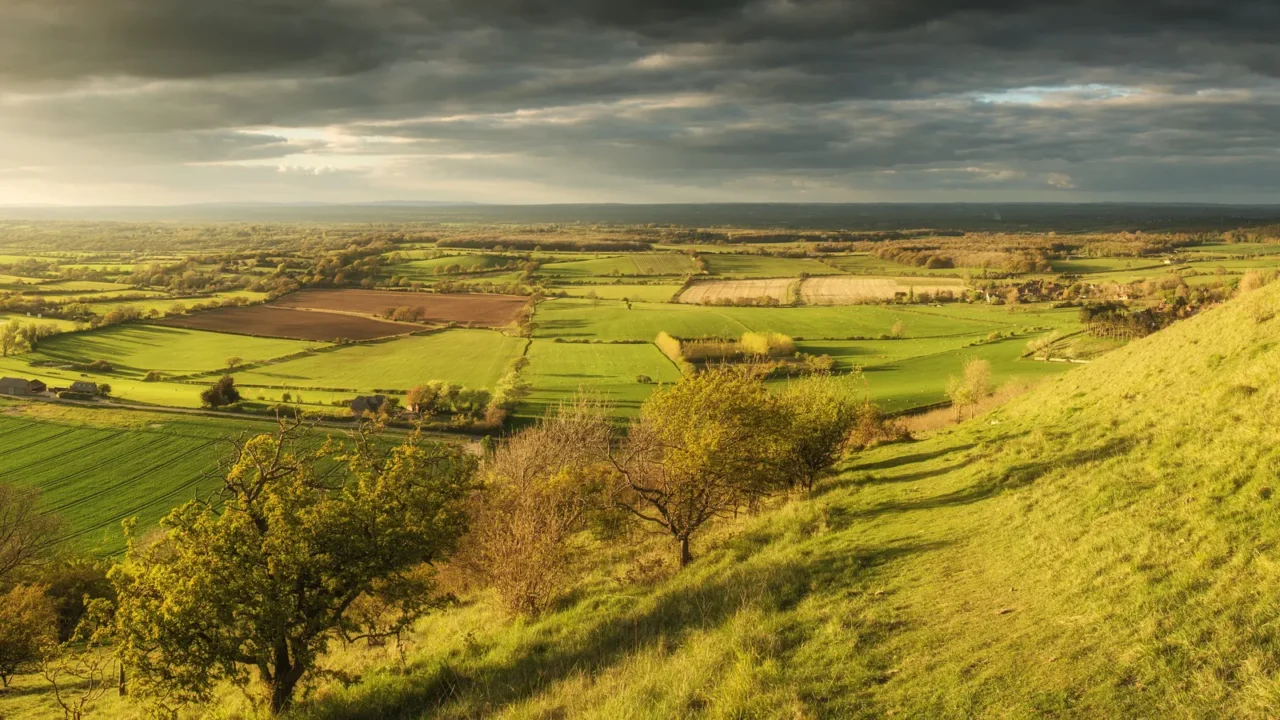 stunning summer sunset across countryside landscape with dramati