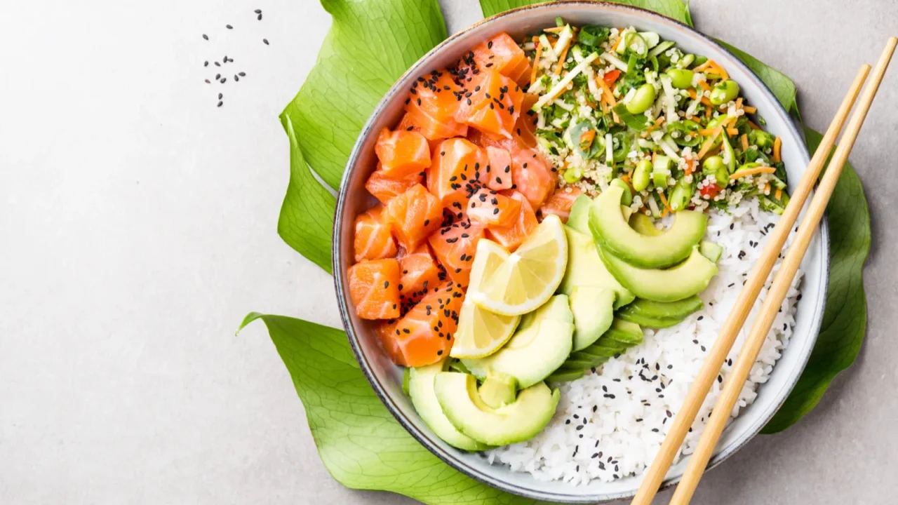 tasty appetizing poke bowl with salmon avocado rice salad with