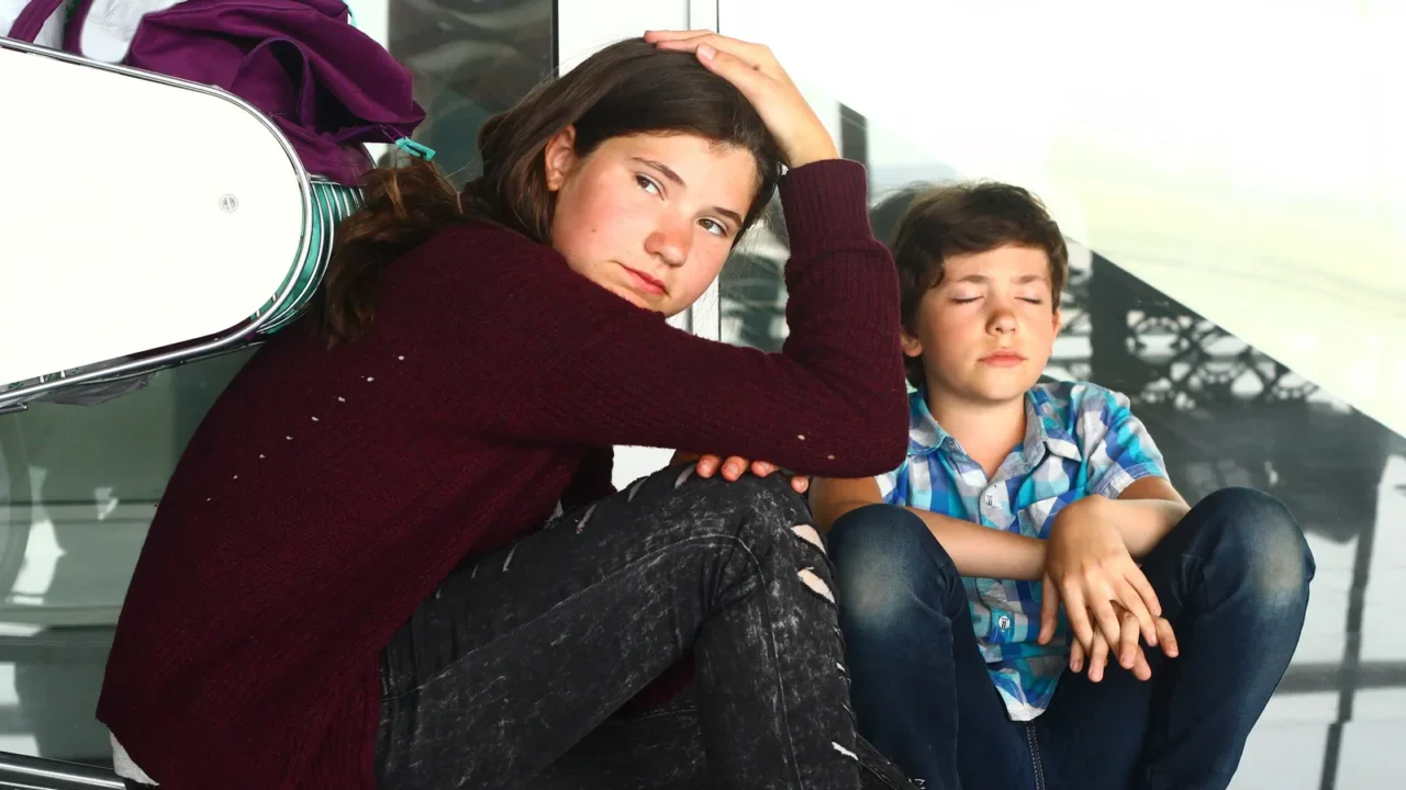 teen boy and girl waiting in the airport