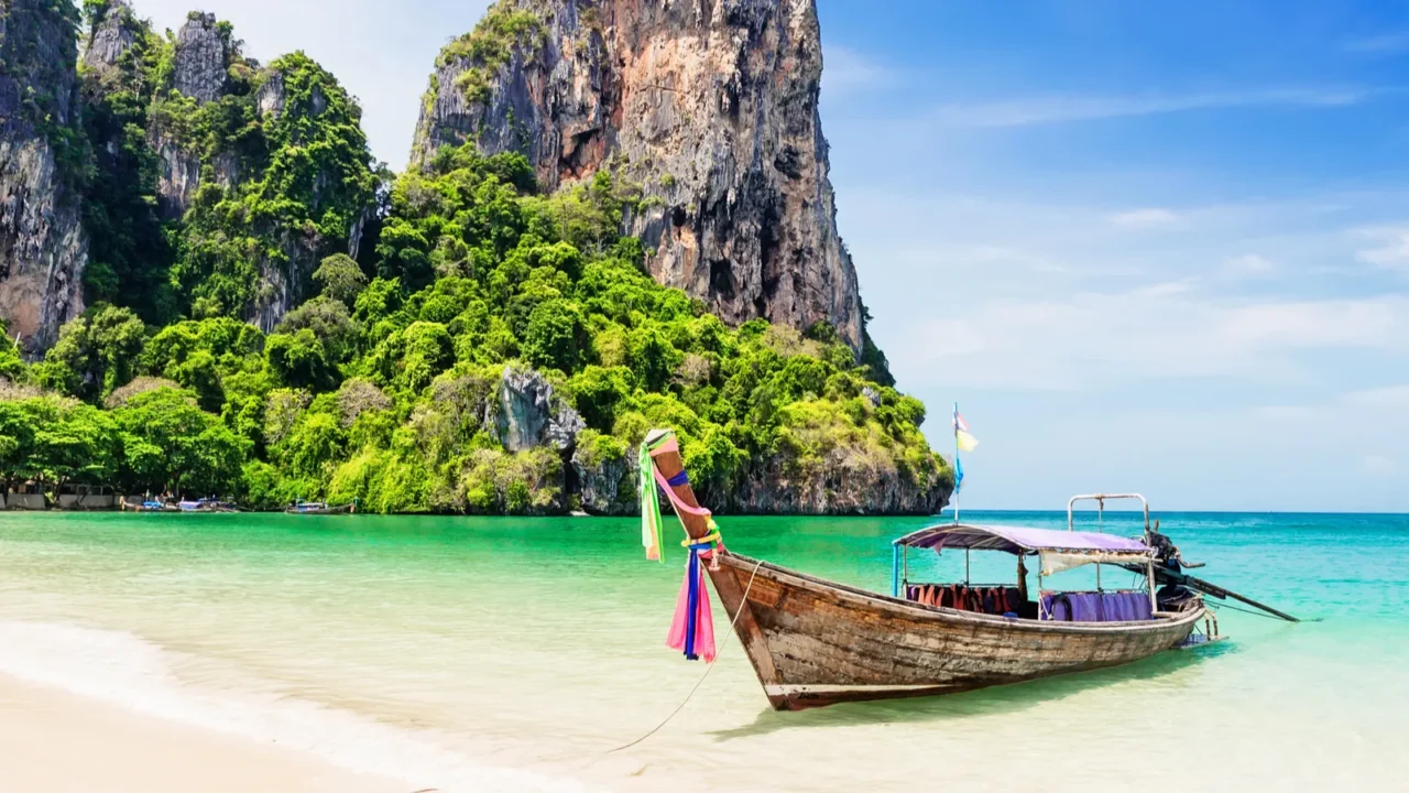 thai traditional wooden longtail boat and beautiful sand beach