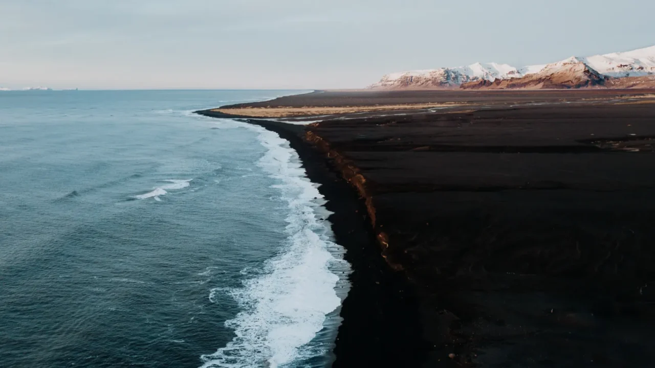 the coast of iceland with a black sand beach and