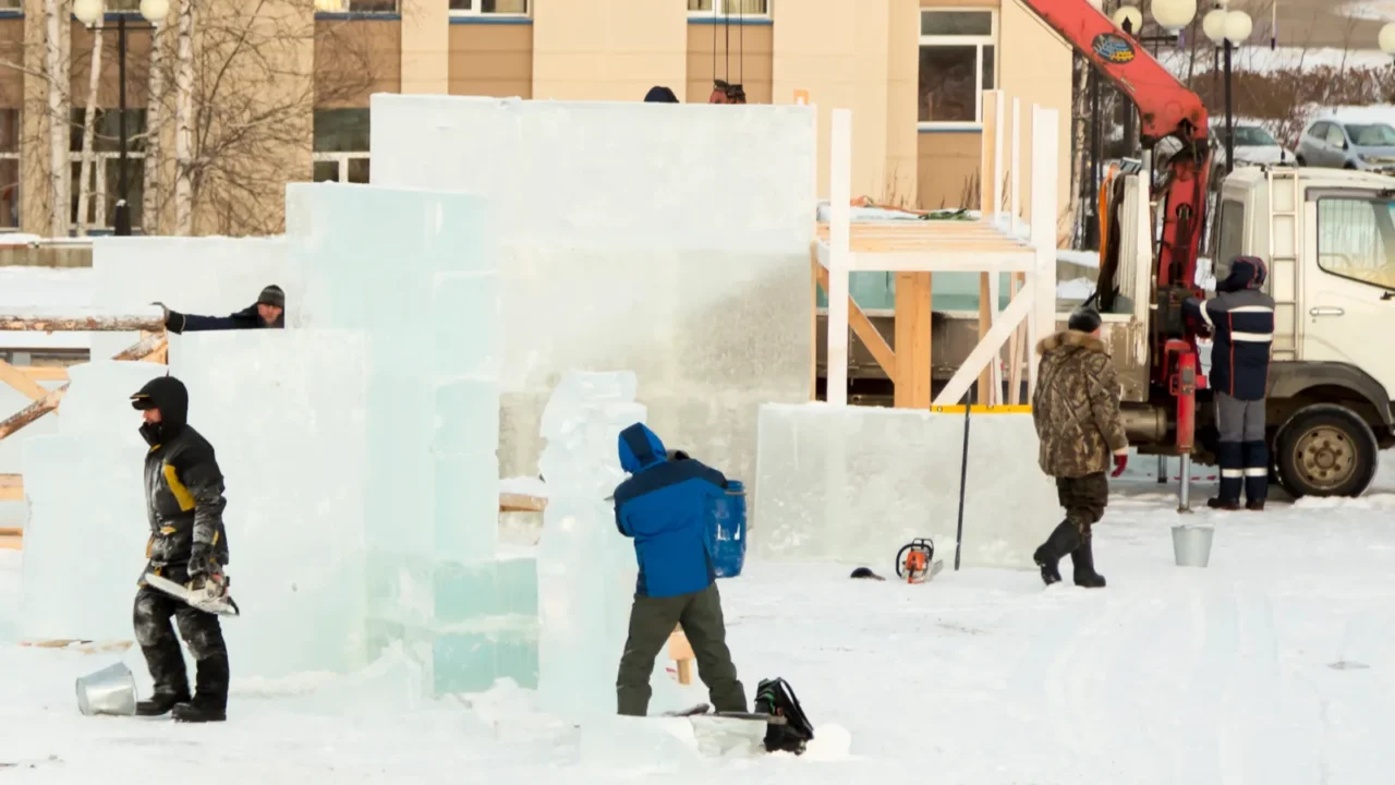 the sculptor cuts an ice figure out of a block