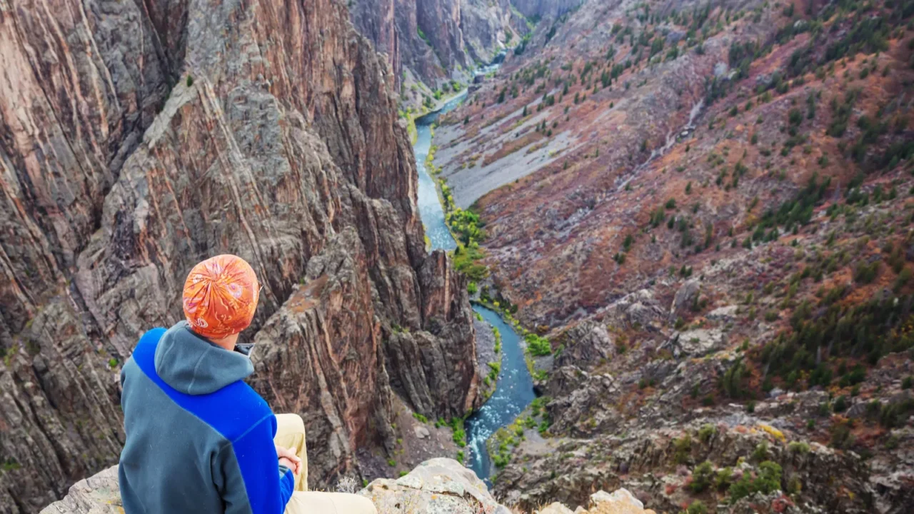 tourist on the granite cliffs of the black canyon of