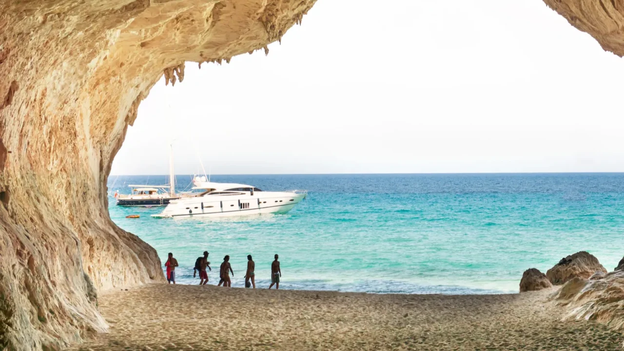 tourists walking near big cave