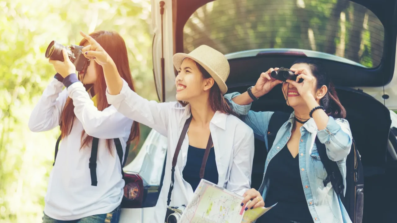 travel group asian woman traveler sitting on hatchback car for
